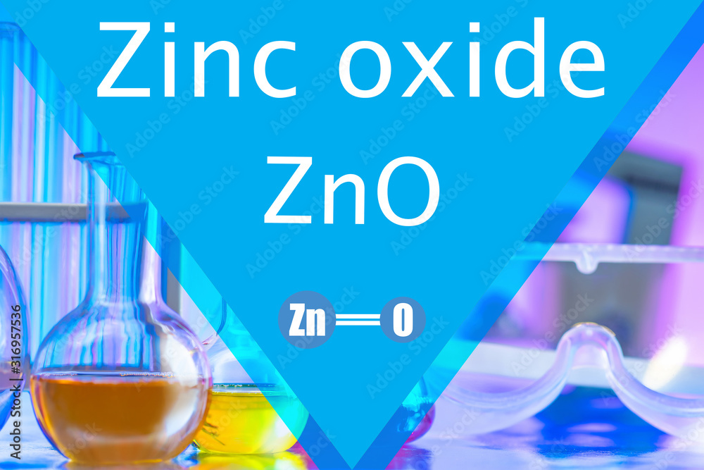 Zinc oxide. Formula ZnO. Test tubes and laboratory glasses are on the ...