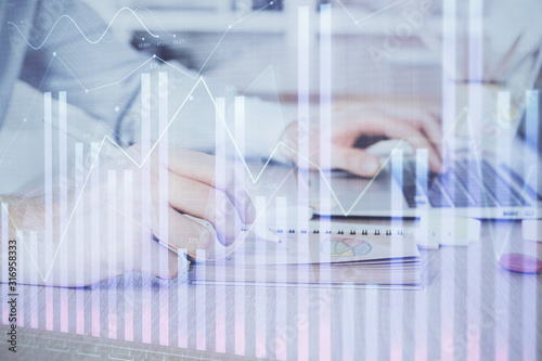 Multi exposure of financial graph with man works in office on background. Concept of analysis.