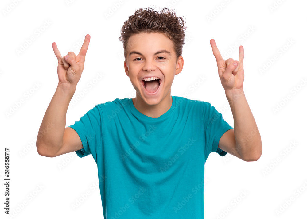 Portrait of funny teen boy making Rock Gesture, isolated on white background. Beautiful caucasian young teenager showing horns up gesture. Happy cute child screaming and doing heavy metal rock sign. Portrait of funny teen boy making Rock Gesture, isolated on white background. Beautiful caucasian young teenager showing horns up gesture. Happy cute child screaming and doing heavy metal rock sign.