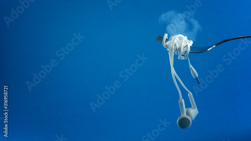 Tableau sur toile Headphone UTP cable wrapped on fork like spaghetti a music addict concept