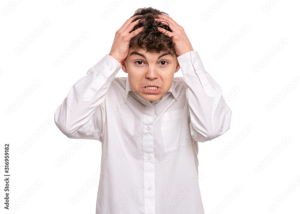 Emotional portrait of upset and angry teen boy isolated on white background. Child looking camera with serious face. Handsome caucasian young teenager with problems. Emotional portrait of upset and angry teen boy isolated on white background. Child looking camera with serious face. Handsome caucasian young teenager with problems.