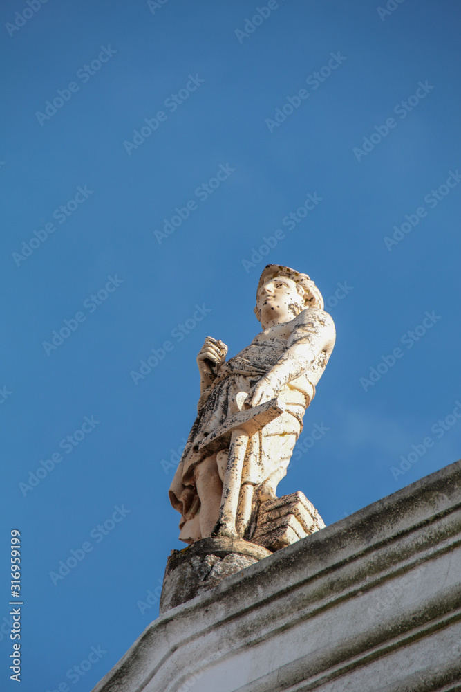 Obraz premium marble statues on top of building