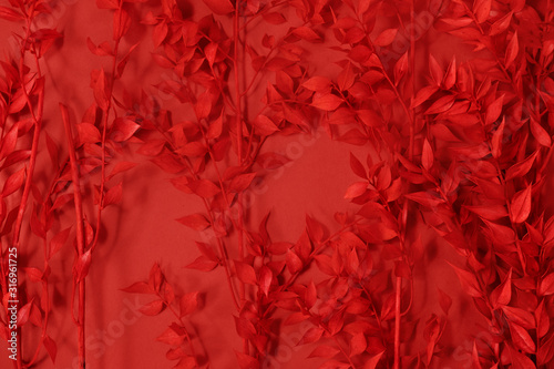 Floral background branches with spring leaves coloured in red