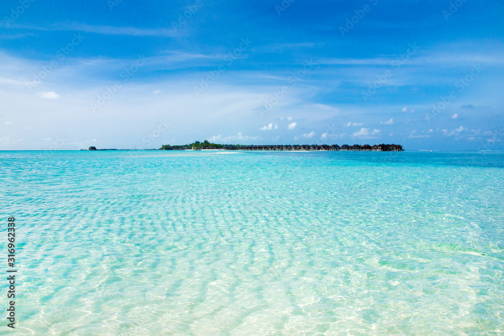 Fototapeta premium Beautiful tropical Maldives island with beach. Sea with water bungalows