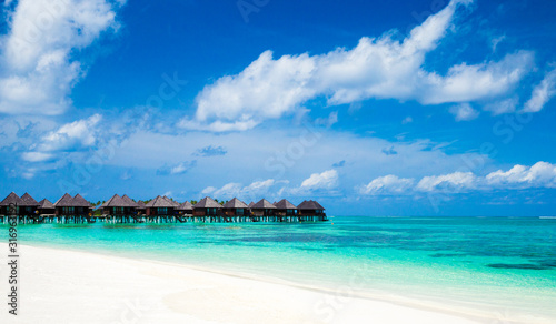 Fototapeta Naklejka Na Ścianę i Meble -  Beautiful tropical Maldives island with beach. Sea with water bungalows