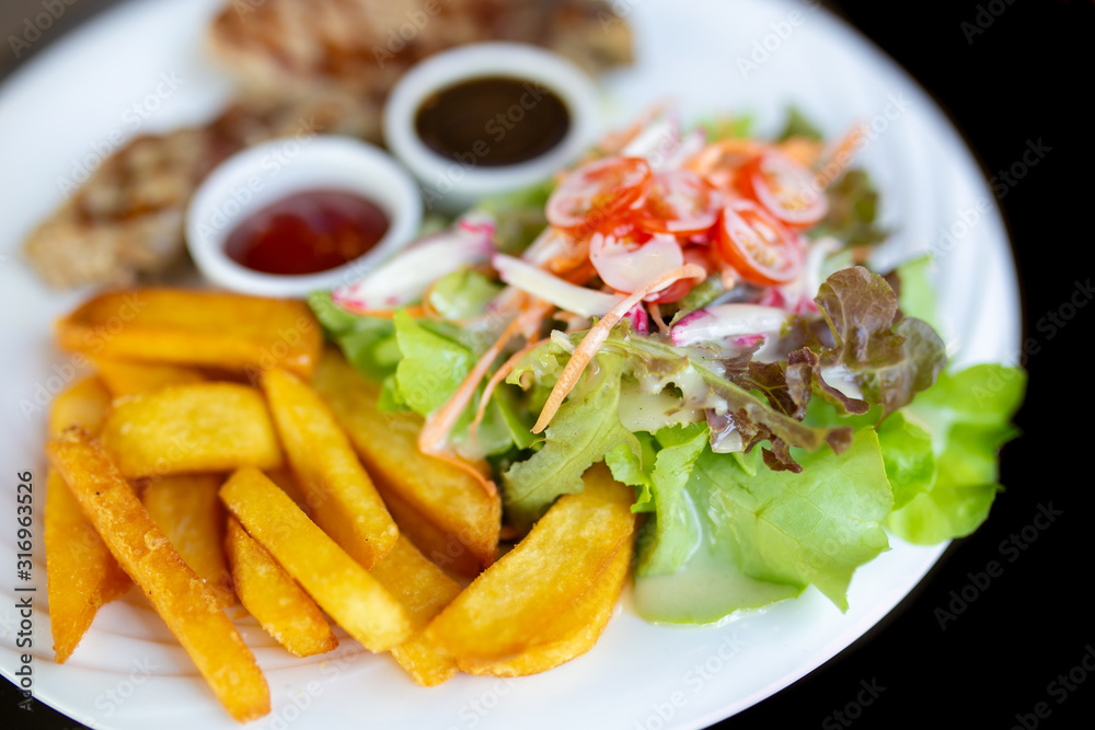 Grilled meat, Porkchops steak with pepper sauce and salad. Grilled meat, Porkchops steak with pepper sauce and salad.
