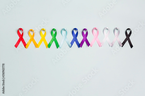 World cancer day concept, February 4. Colorful awareness ribbons on blue background.