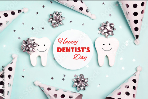 Happy Dentist's Day greeting card with teeth and holiday caps on a blue.