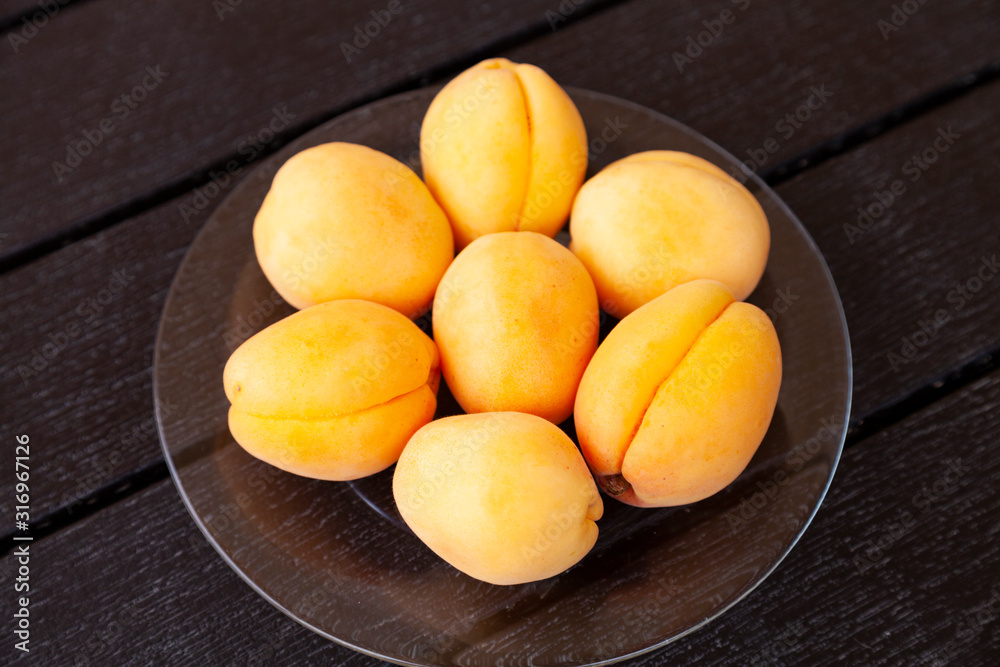Ripe apricots on a wooden table.
