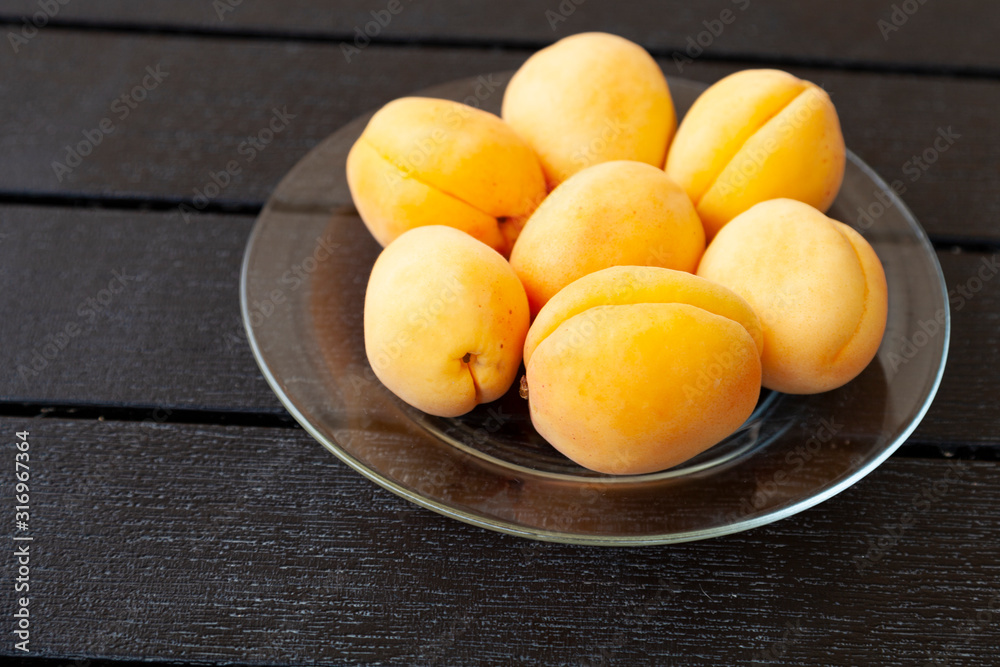 Ripe apricots on a wooden table.