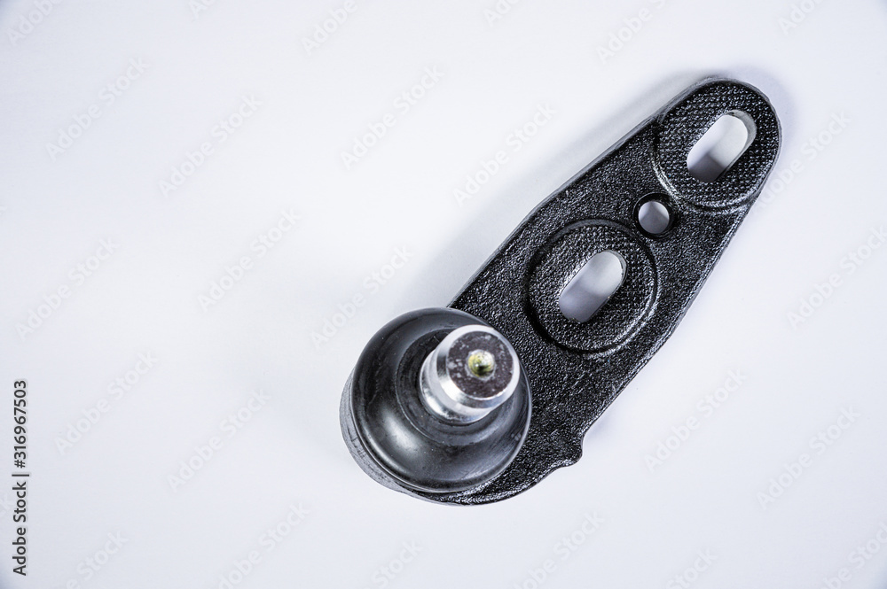 New spare parts spherical ball joints of a suspension bracket of a car on a gray background New spare parts spherical ball joints of a suspension bracket of a car on a gray background