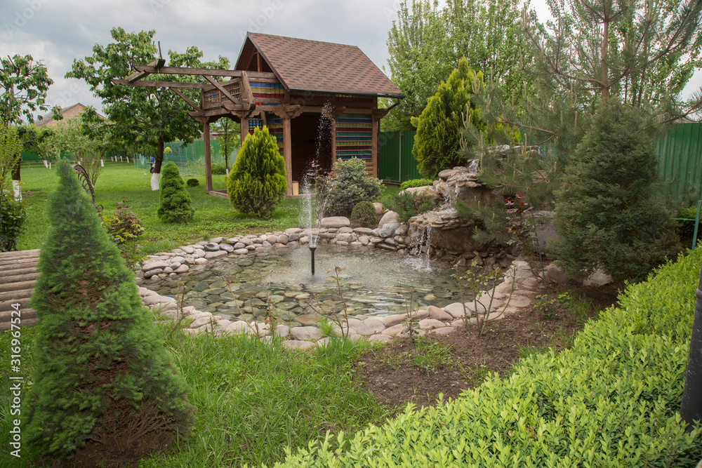 Beautiful nature with a fountain in the country cottage