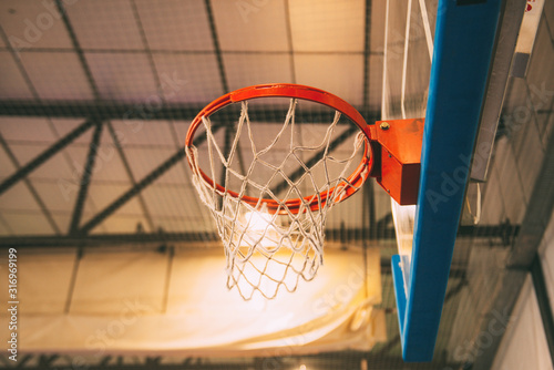 Interior of school gym with basketball board and basket © JAVIER LARRAONDO