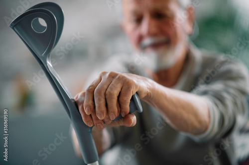 Old man with crutches. Senior man having pain.