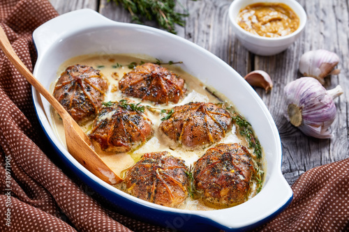 rabbit ballotine in a ceramic baking dish photo