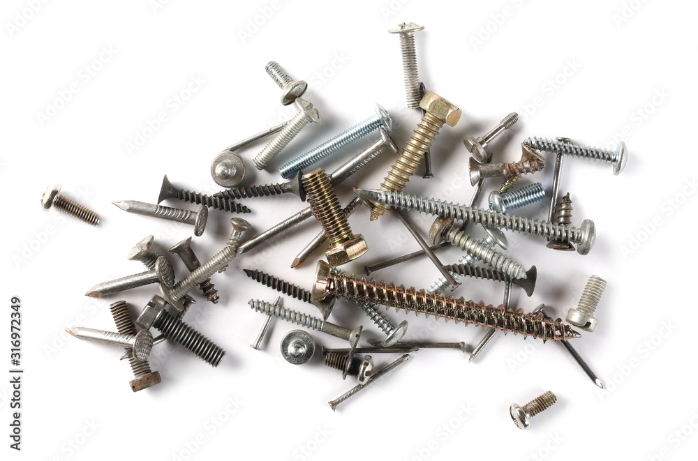Metal nails, screws and bolts pile isolated on white background, top view Metal nails, screws and bolts pile isolated on white background, top view