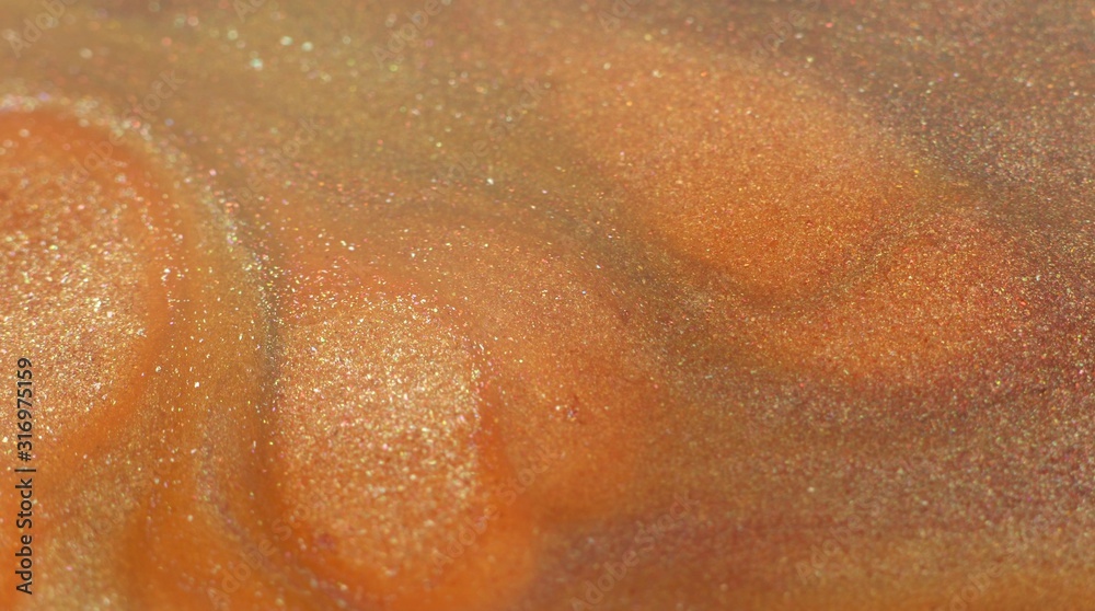 Fototapeta premium Orange coral peachy paint. Shiny particles motion. Liquid glitter texture. Abstract macro background. Psychedelic magic movement