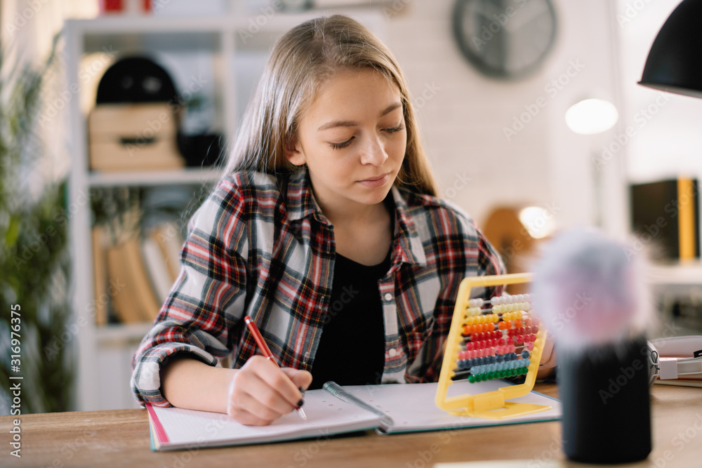 Beautiful girl learning at home. Schoolgirl doing homework. Beautiful girl learning at home. Schoolgirl doing homework.
