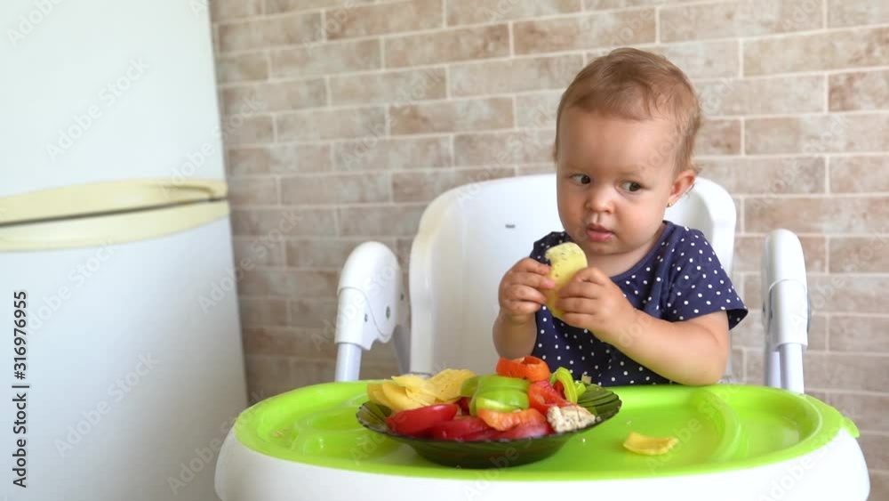 Child feeding cat at home. Little girl playing with kitten in light kitchen. Domestic animals and pets for children Child feeding cat at home. Little girl playing with kitten in light kitchen. Domestic animals and pets for children