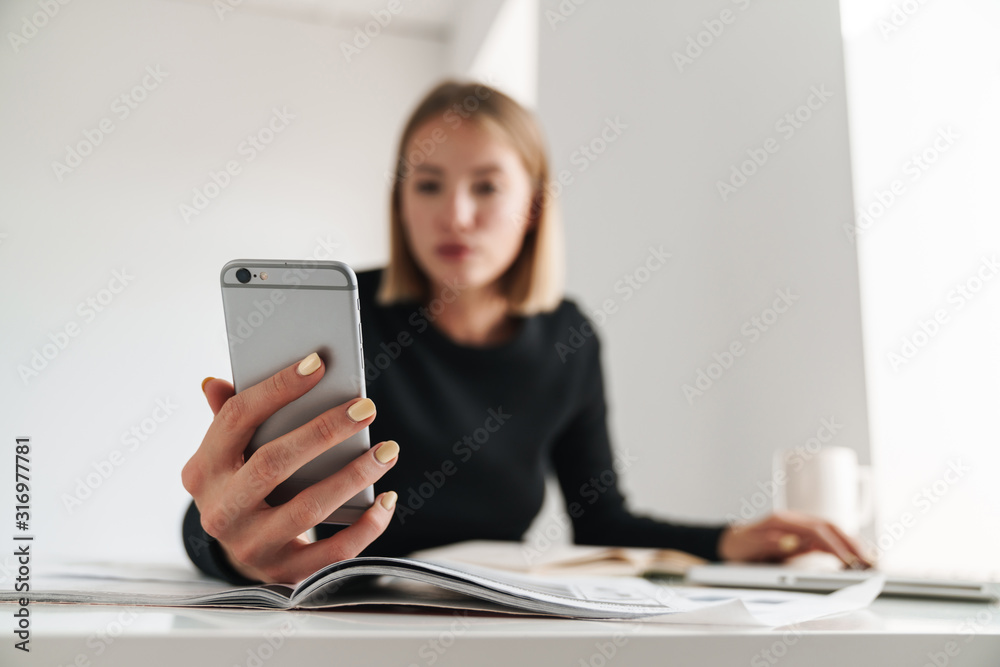 Business woman in office work with documents and phone. Business woman in office work with documents and phone.