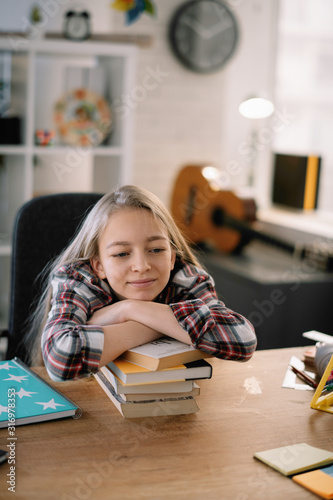 Cute little girl. Tired schoolgirl learning. 