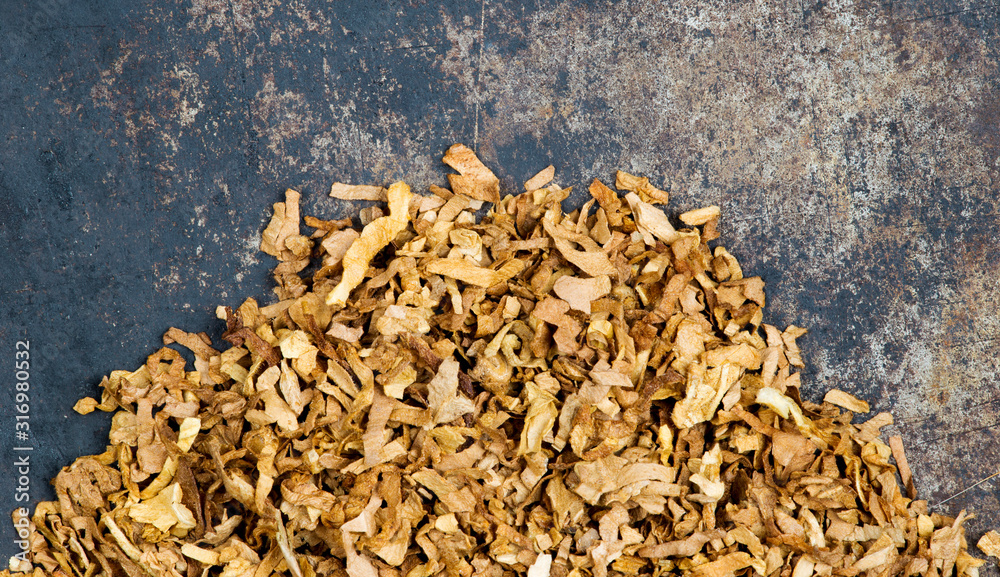 Tobacco heap closeup backdrop background, top view, copy space