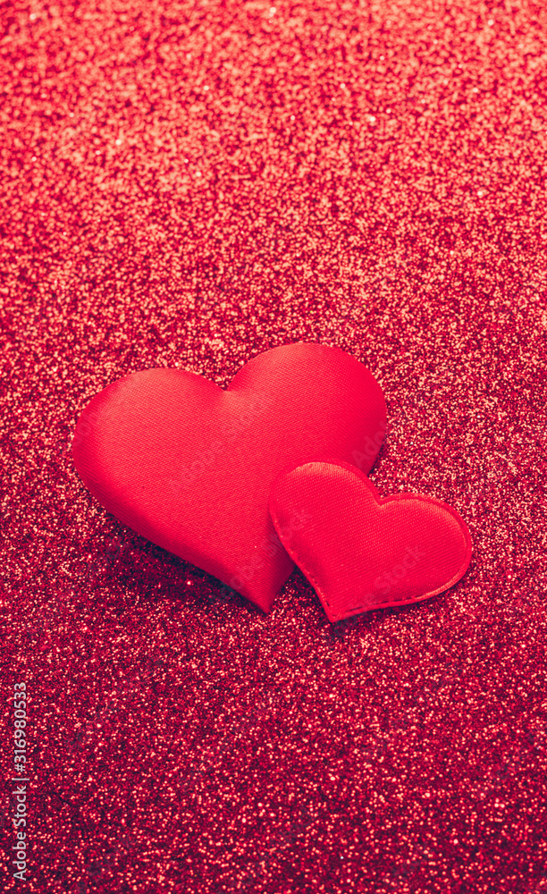 Two red heart symbol of love on a shiny background. Valentines day concept. Vertical frame copy space. Two red heart symbol of love on a shiny background. Valentines day concept. Vertical frame copy space.