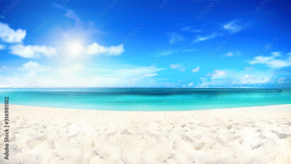 Beautiful beach with white sand, turquoise ocean water and blue sky with clouds in sunny day. Natural background for summer vacation, soft focus.