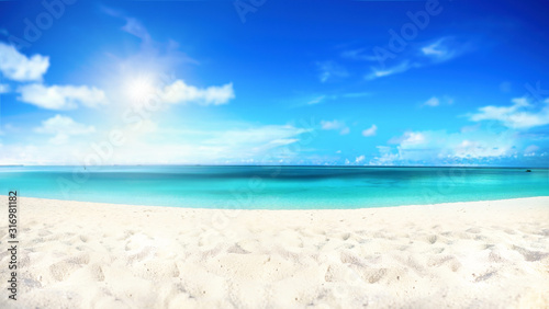 Fototapeta Naklejka Na Ścianę i Meble -  Beautiful beach with white sand, turquoise ocean water and blue sky with clouds in sunny day. Natural background for summer vacation, soft focus.