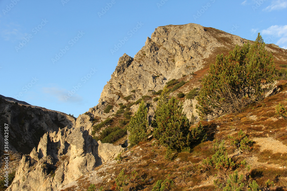 Mountains, sun and blue sky on summer day. Beautiful mountain background