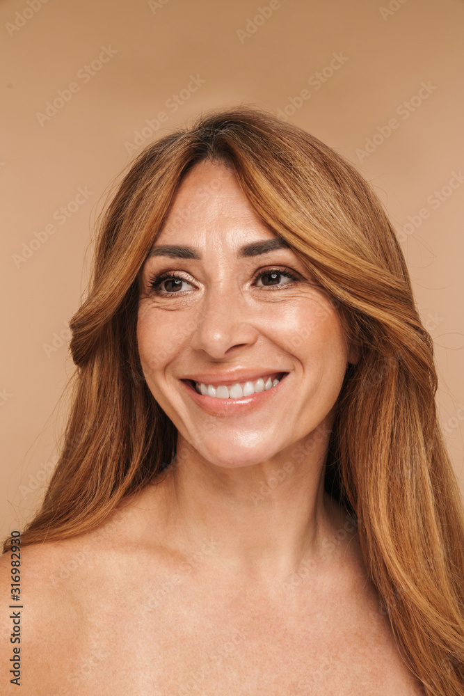 Portrait of shirtless adult woman looking aside and smiling Portrait of shirtless adult woman looking aside and smiling