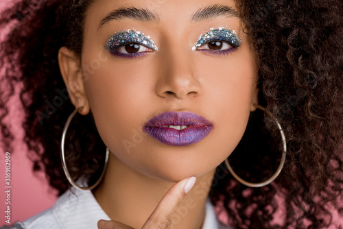 Wall Mural attractive african american girl with silver glitter eyeshadows and purple lips,