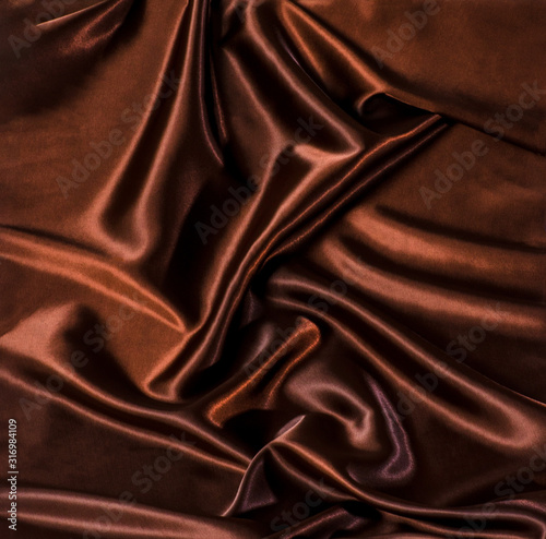 Abstract brown wavy textile silk background with chocolate, cocoa, coffee color