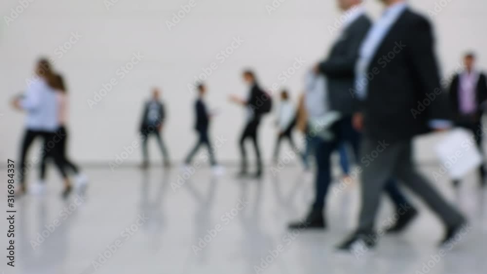 Blurred crowd of people passing close by at a business fair Blurred crowd of people passing close by at a business fair