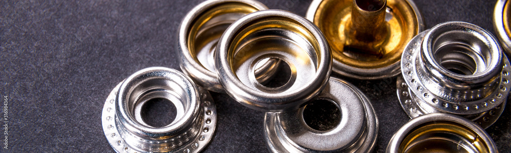 Banner of Detail for metal buttons for clothing on black background. Banner of Detail for metal buttons for clothing on black background.