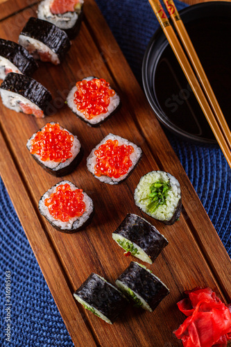 A set of sushi rolls with red caviar, ginger and wasabi