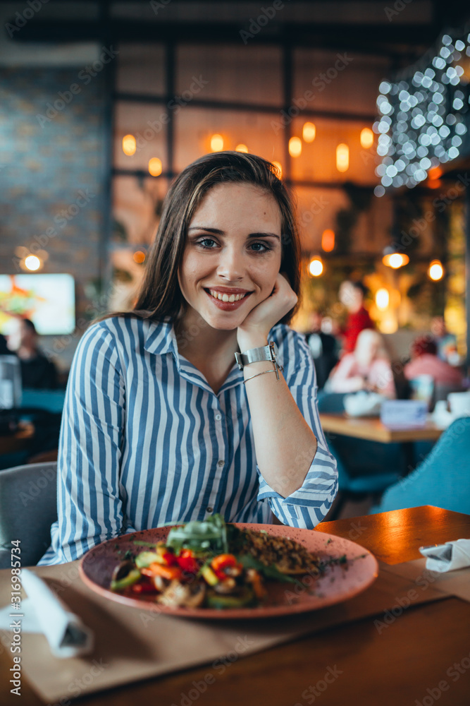 portrait of woman in restaurant eating