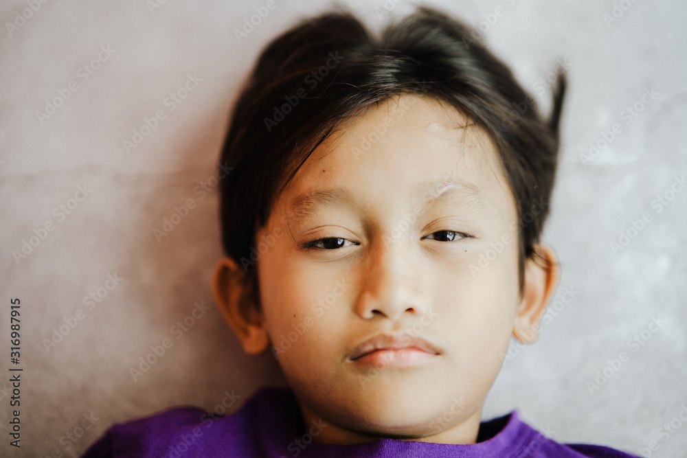Little boy portrait close up face on concrete background Little boy portrait close up face on concrete background