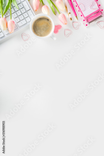 Modern office desk workspace with laptop keyboard, notebook and stationery. Springtime and valentine day pastel workspace background. Flat lay lifestyle with copy space