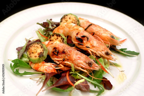 Italian food recipes, grilled shrimp skewer and fresh salad