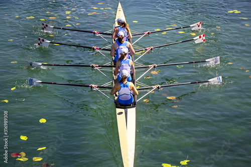 Women's quadruple rowing team on green lake