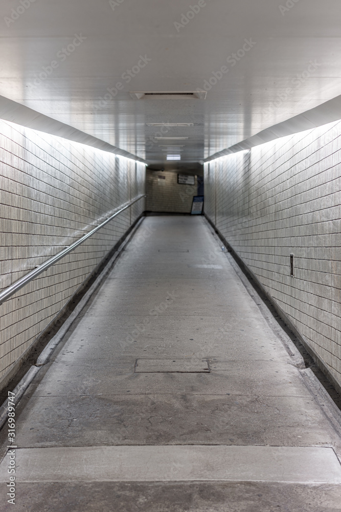 Empty pedestrian underground tunnel of a city train station Empty pedestrian underground tunnel of a city train station