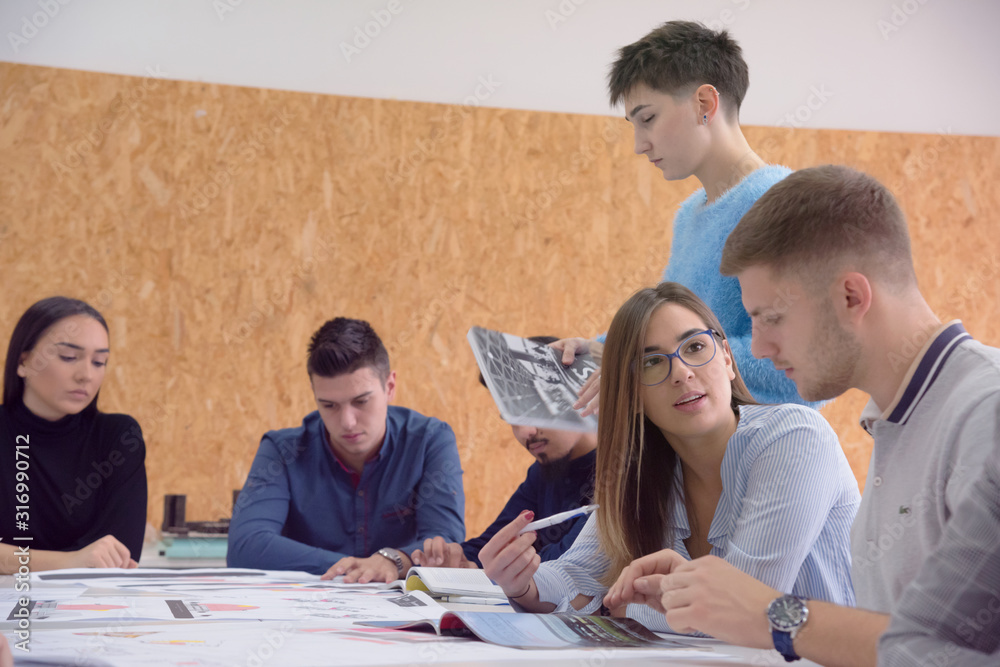 Fototapeta premium Group of university architecture students working on practice lessons. Looking for solution during class.