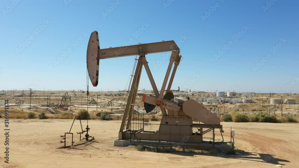 Oil Pump jack. Oil industry equipment. Morning, blue sky. California state. USA country Oil Pump jack. Oil industry equipment. Morning, blue sky. California state. USA country
