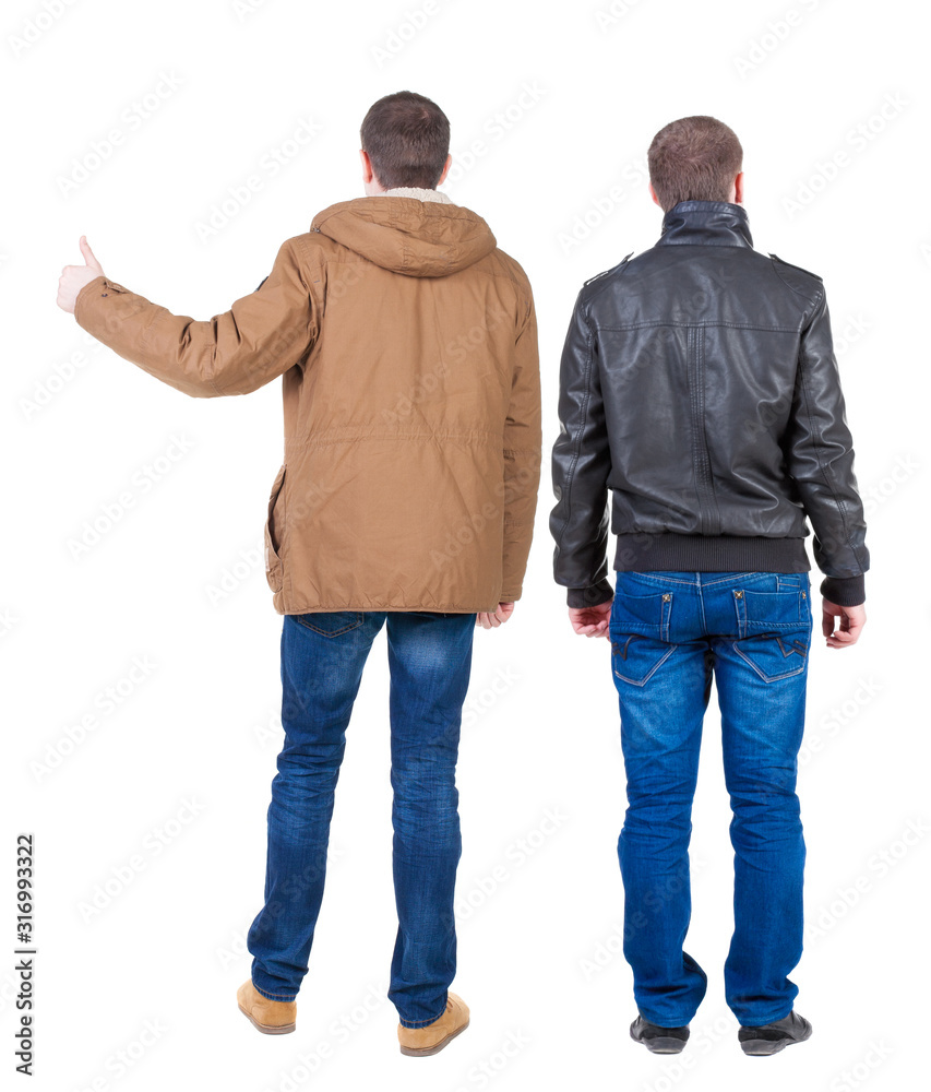 Back view of two man in winter jacket showing thumb up. Back view of two man in winter jacket showing thumb up.