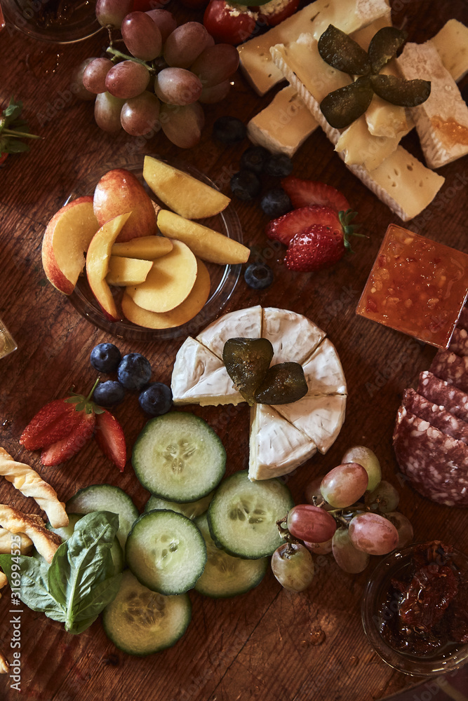 Fototapeta premium Food plate with various snacks, cheese, fruit and vegetables