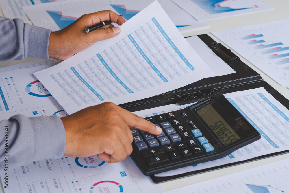 businessman working calculate data document graph chart report marketing research development planning management strategy analysis financial accounting. Business office concept. businessman working calculate data document graph chart report marketing research development planning management strategy analysis financial accounting. Business office concept.