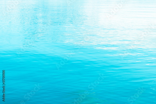 Tranquil surface texture of the ocean. Water ripples. Blue sea water in calm. Crystal clear sea water texture background. Turquoise ripple tropical water reflection. Blue ocean wave. Summer sea