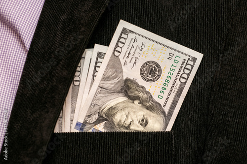 Dollars in  jacket pocket rich man's. American currency_