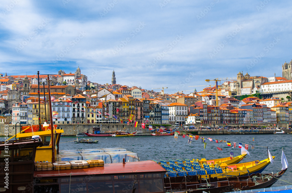 Portugal, Porto, colored houses of old town in Porto, colorful boats on Douro river, Porto by river, Porto old town view, yellow boats on the river, boats with flags of different countries
